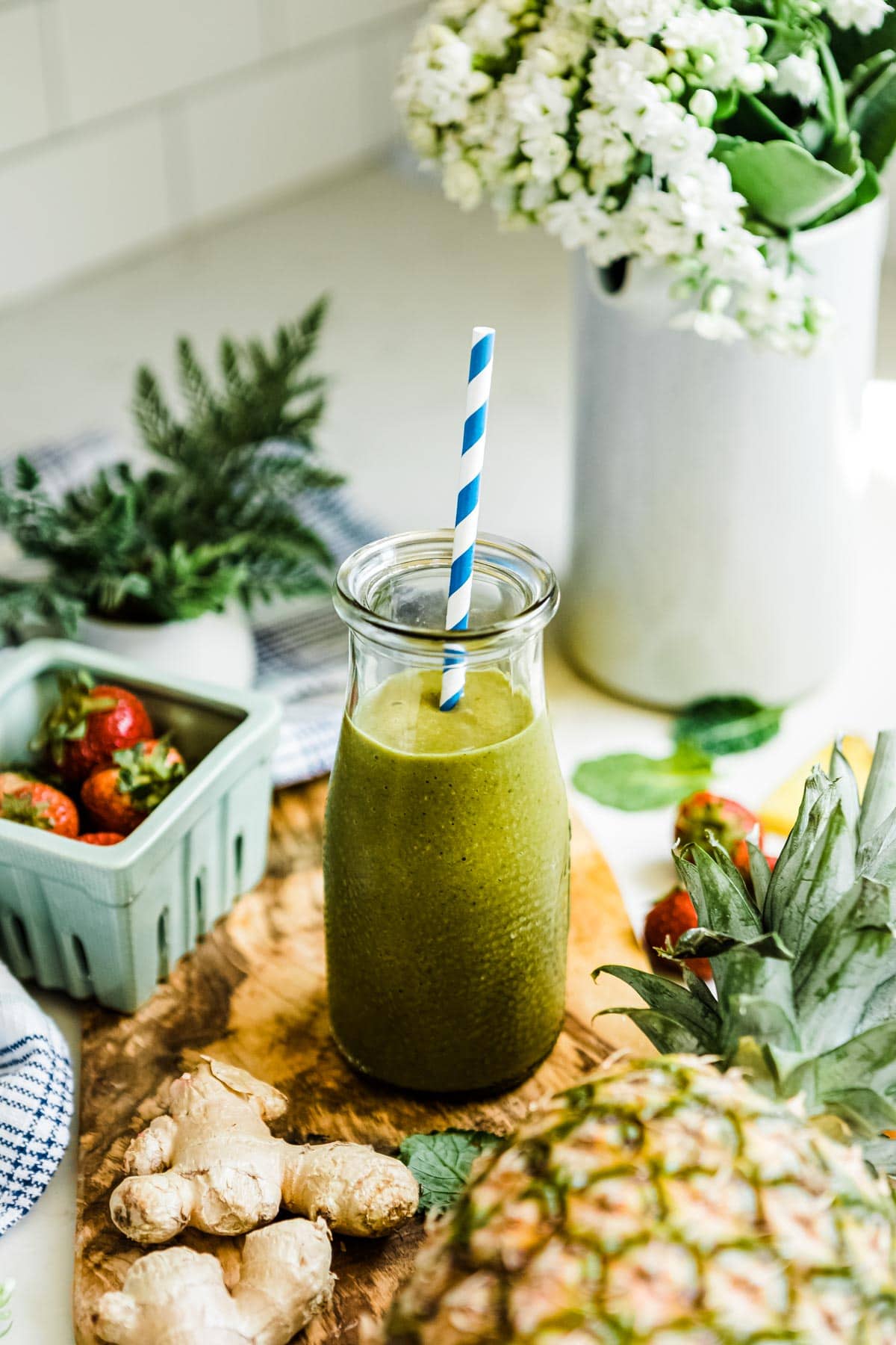 ginger smoothie with plant based ingredients in a glass jar on a wooden plank