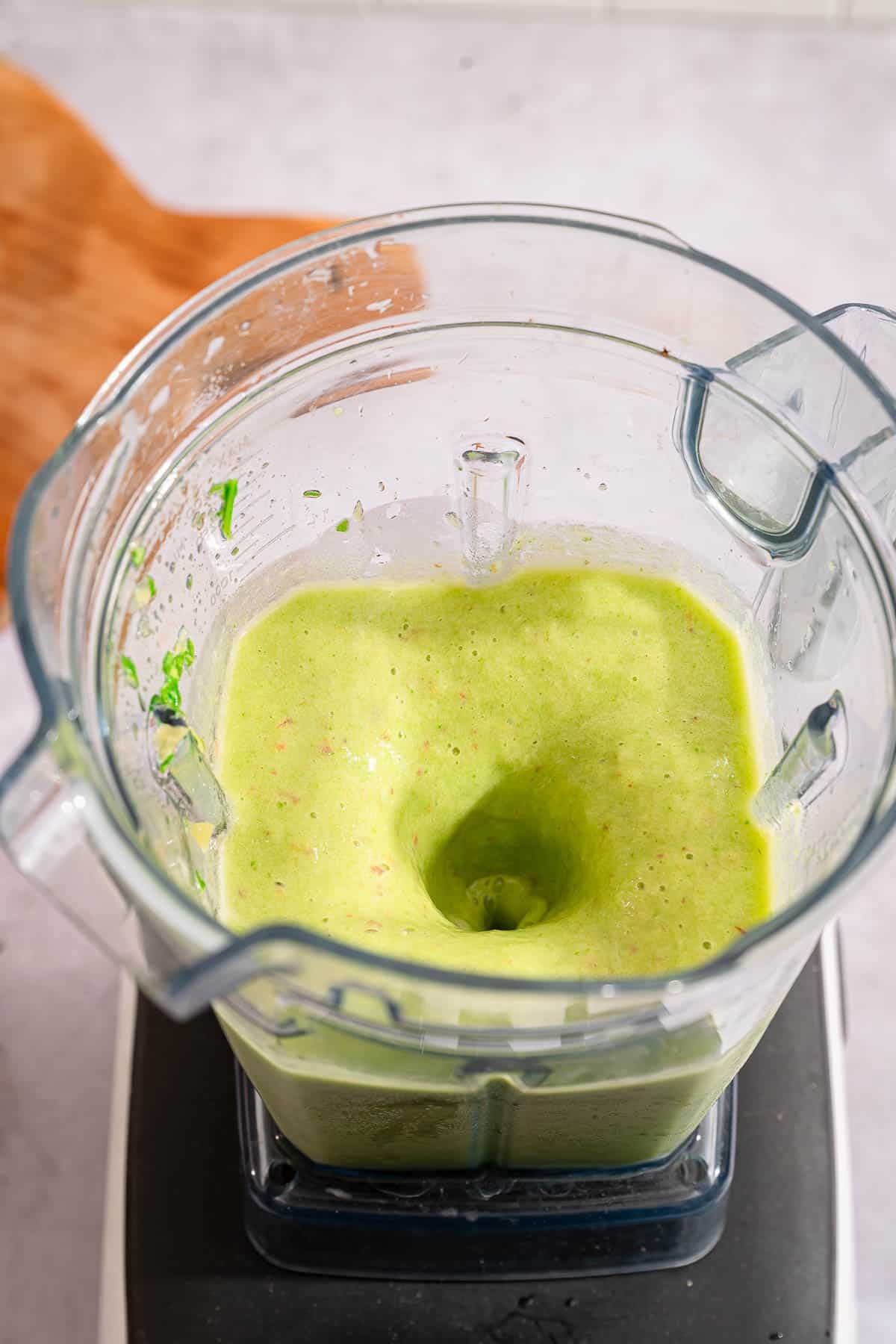 Blended spinach pineapple smoothie in a blender.
