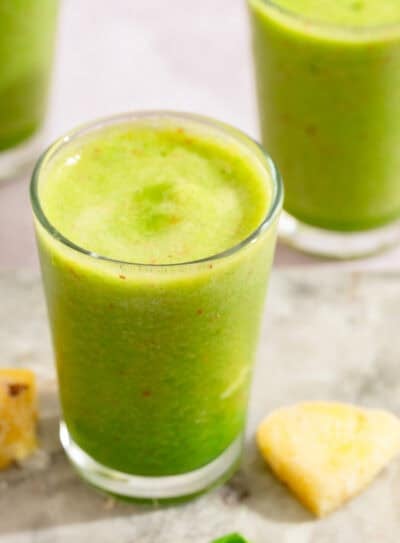 Tropical pineapple spinach smoothie in a glass