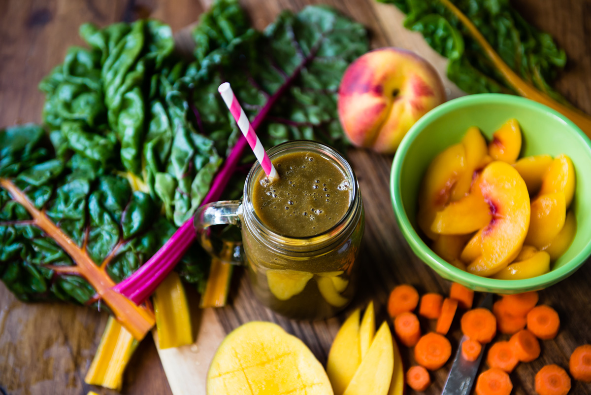 Mason jar with pregnancy smoothie on table with paper straw.
