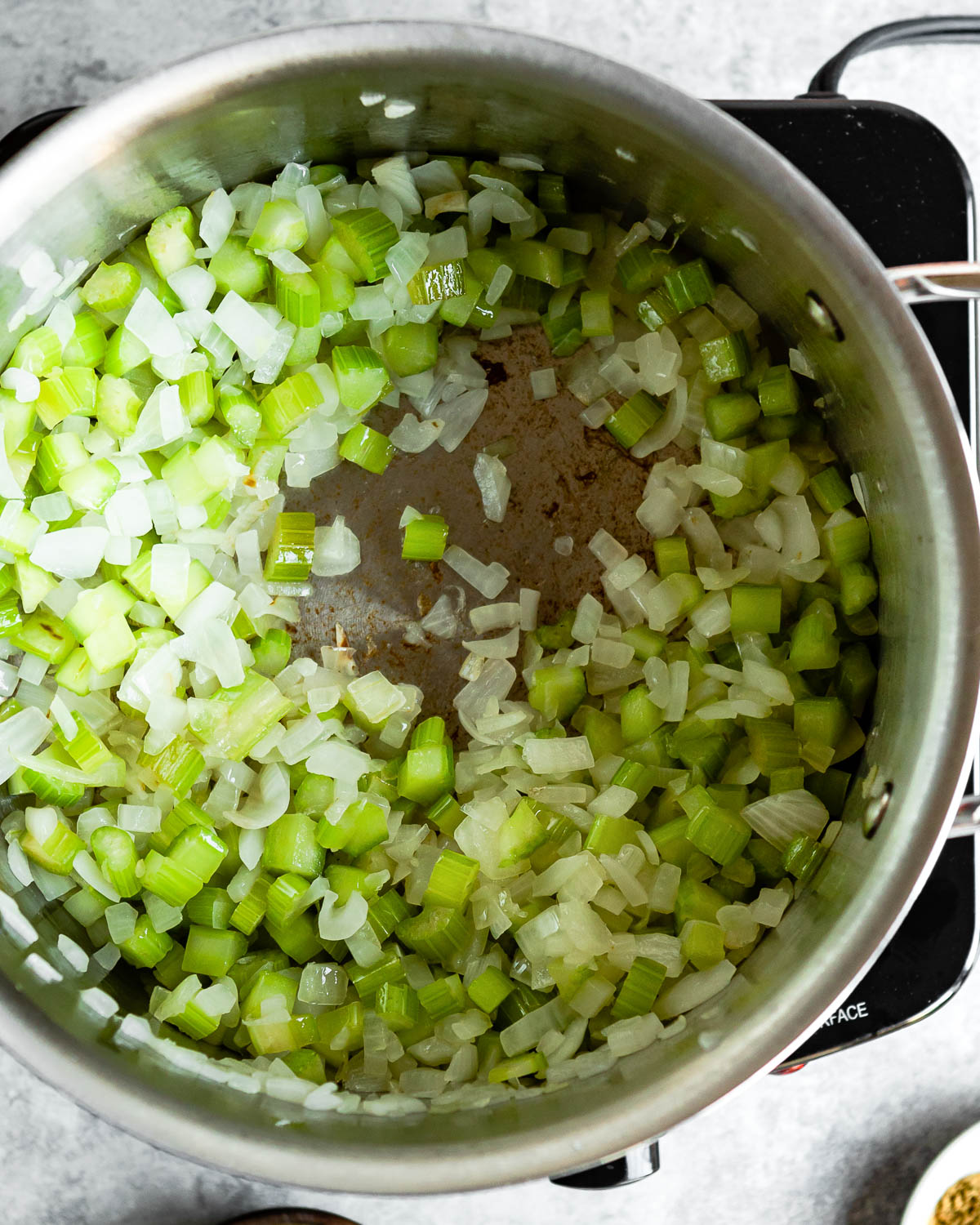 Sautéing onion and celery in a pot