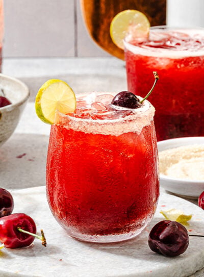 Refreshing summer drink in a glass, surrounded by fresh ingredients