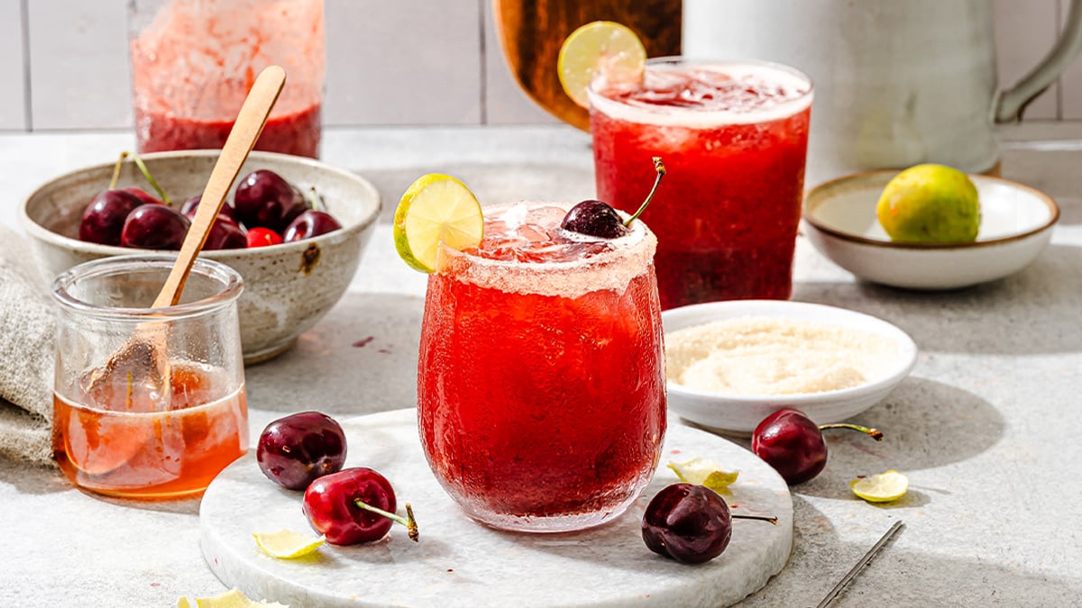 Refreshing summer drink in a glass, surrounded by fresh ingredients