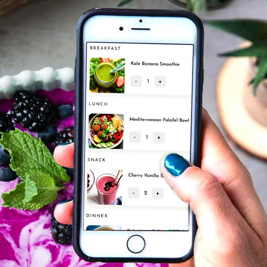 Female holding iphone with recipes and meal plans on the screen.