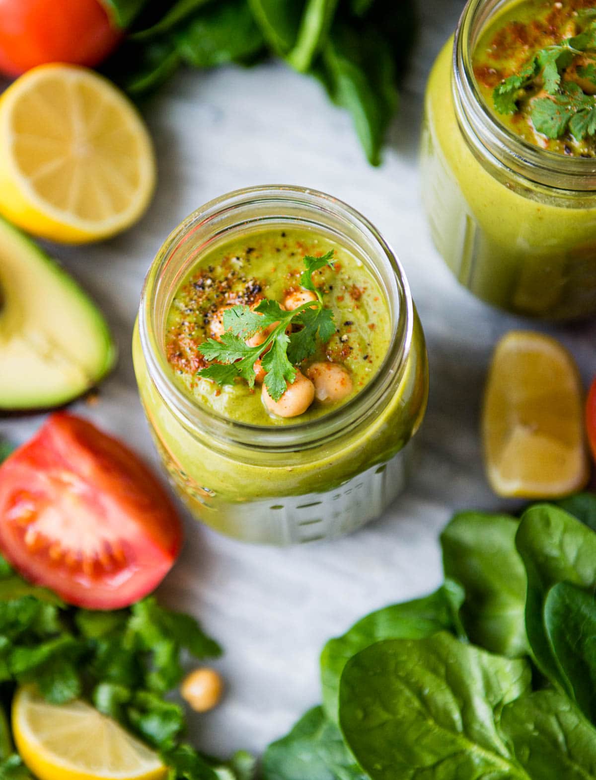 2 savory smoothies topped with chickpeas, cilantro and spices.