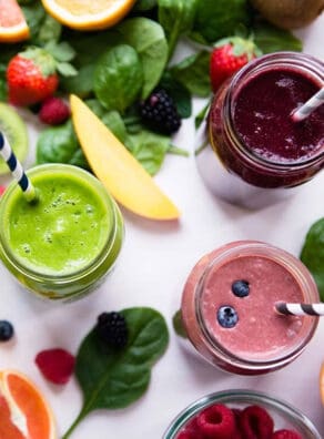 Colorful smoothies with fresh fruits and leafy greens for healthy living.