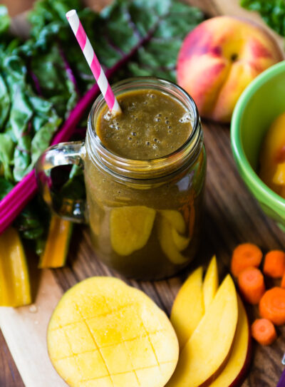 Pregnancy smoothie in a mason jar surrounded by fresh fruit.
