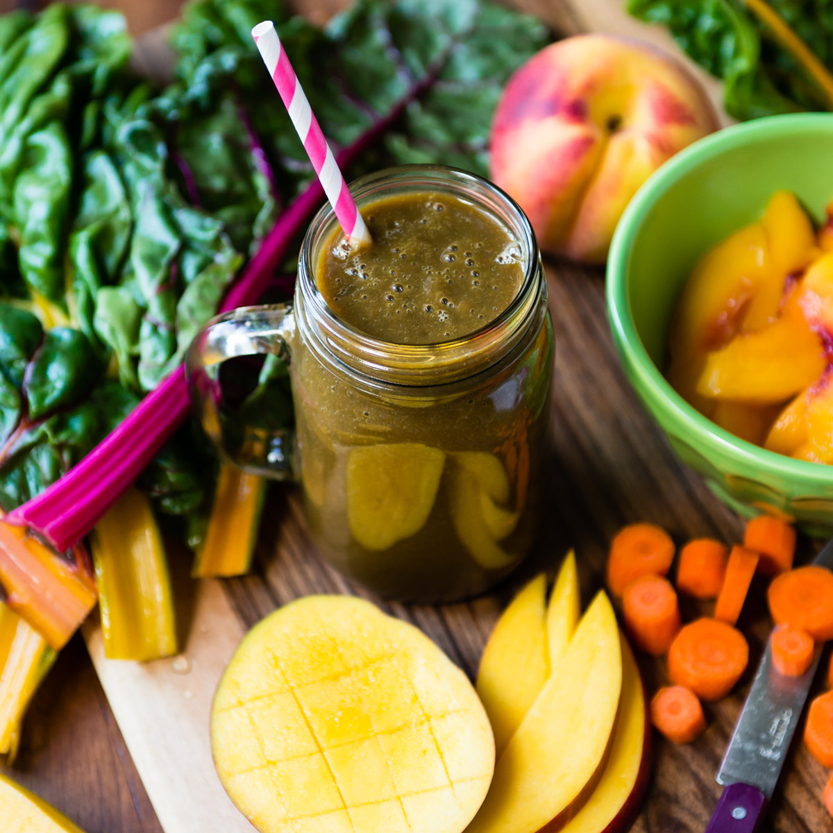 Pregnancy smoothie in a mason jar surrounded by fresh fruit.