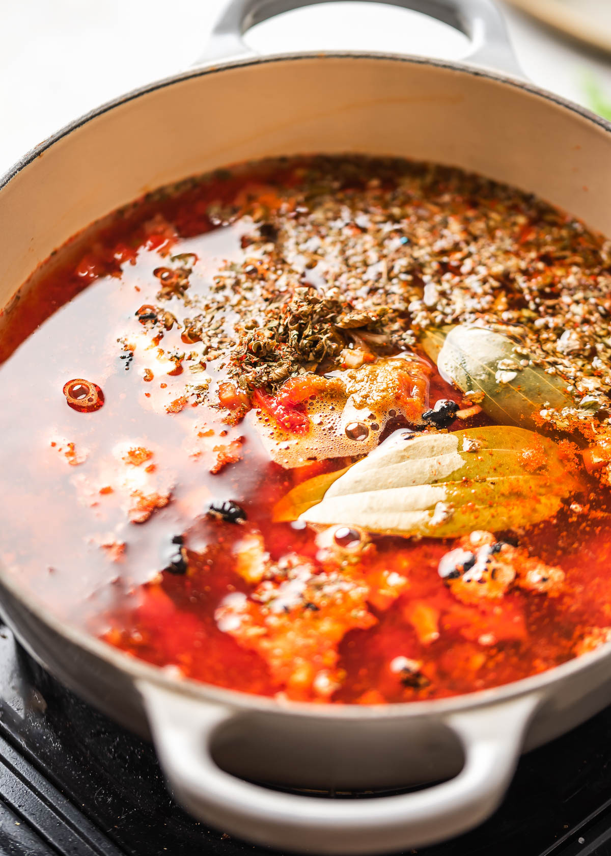 A pot of simmering spicy black bean soup. 