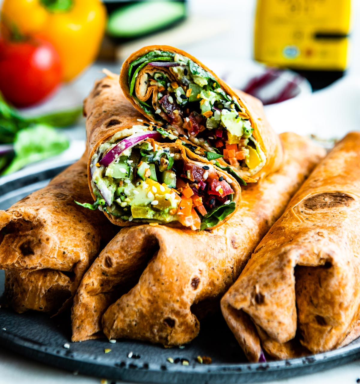 plate of vegetarian hummus wraps using spring ingredients.