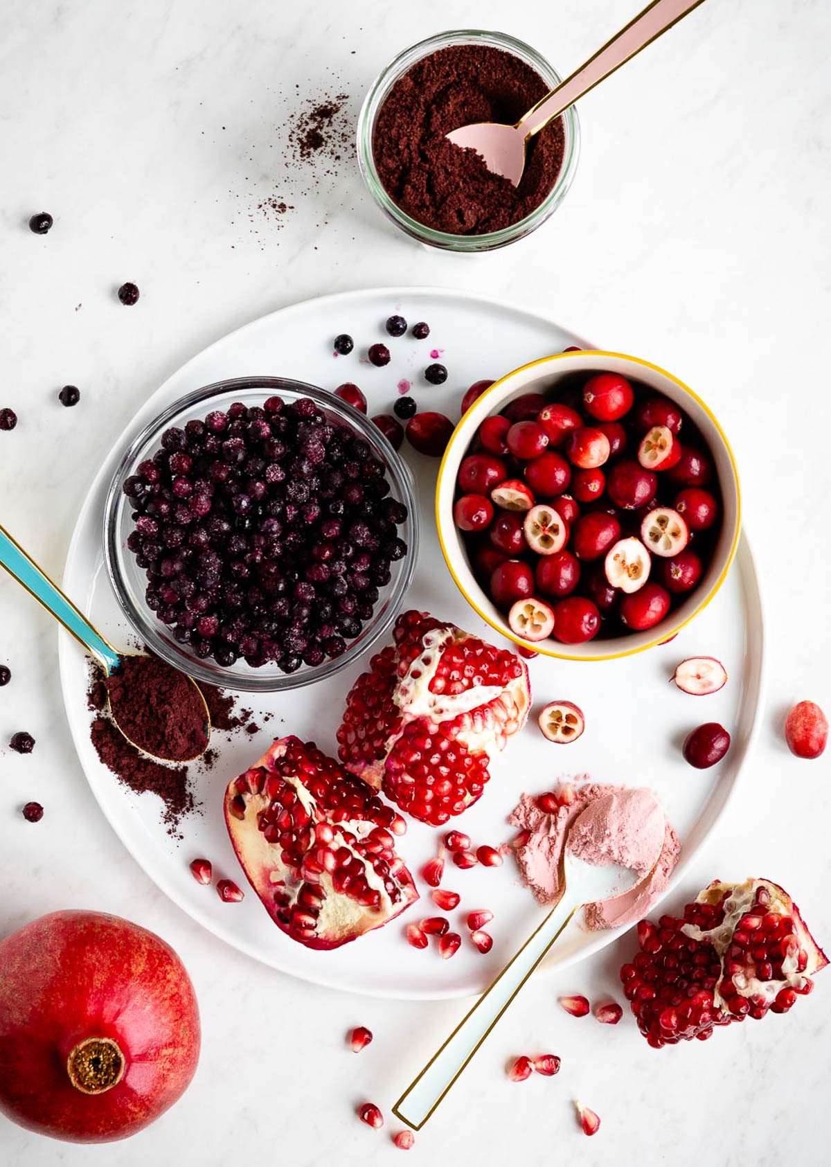 superfood berries on a white tray including blueberries, cranberries and pomegranate.