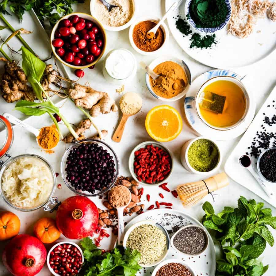 white counter full of bowls of different superfoods.