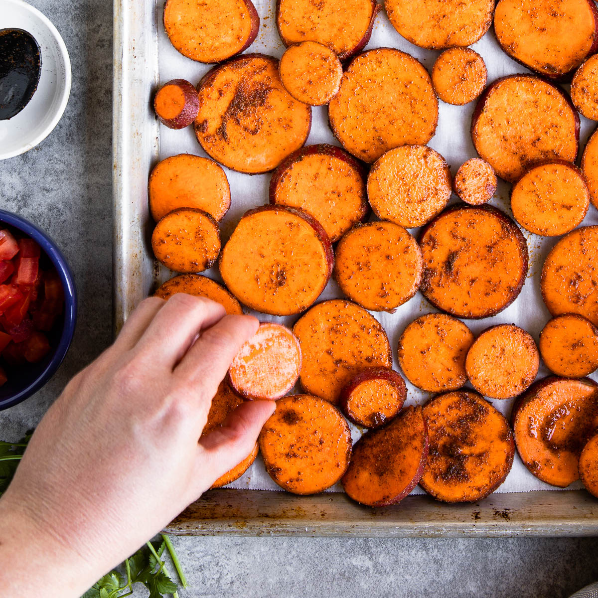 Arranging sweet potatoes on a sheet pan