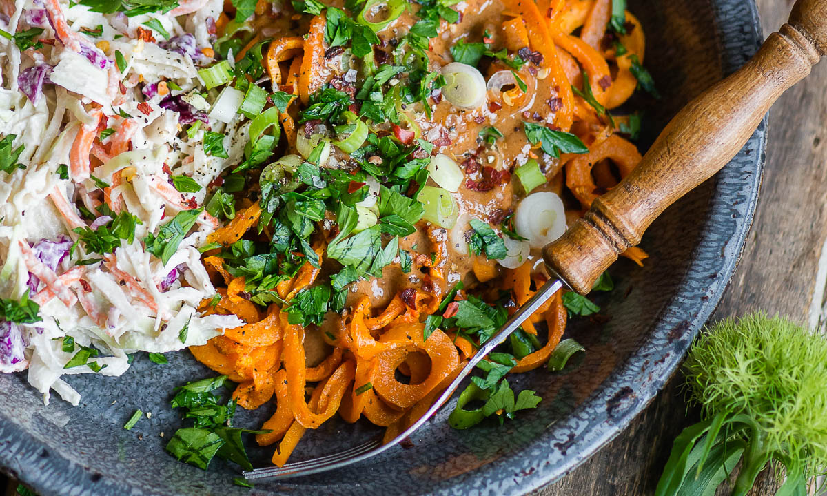 gluten-free noodles and coleslaw in a gray bowl.