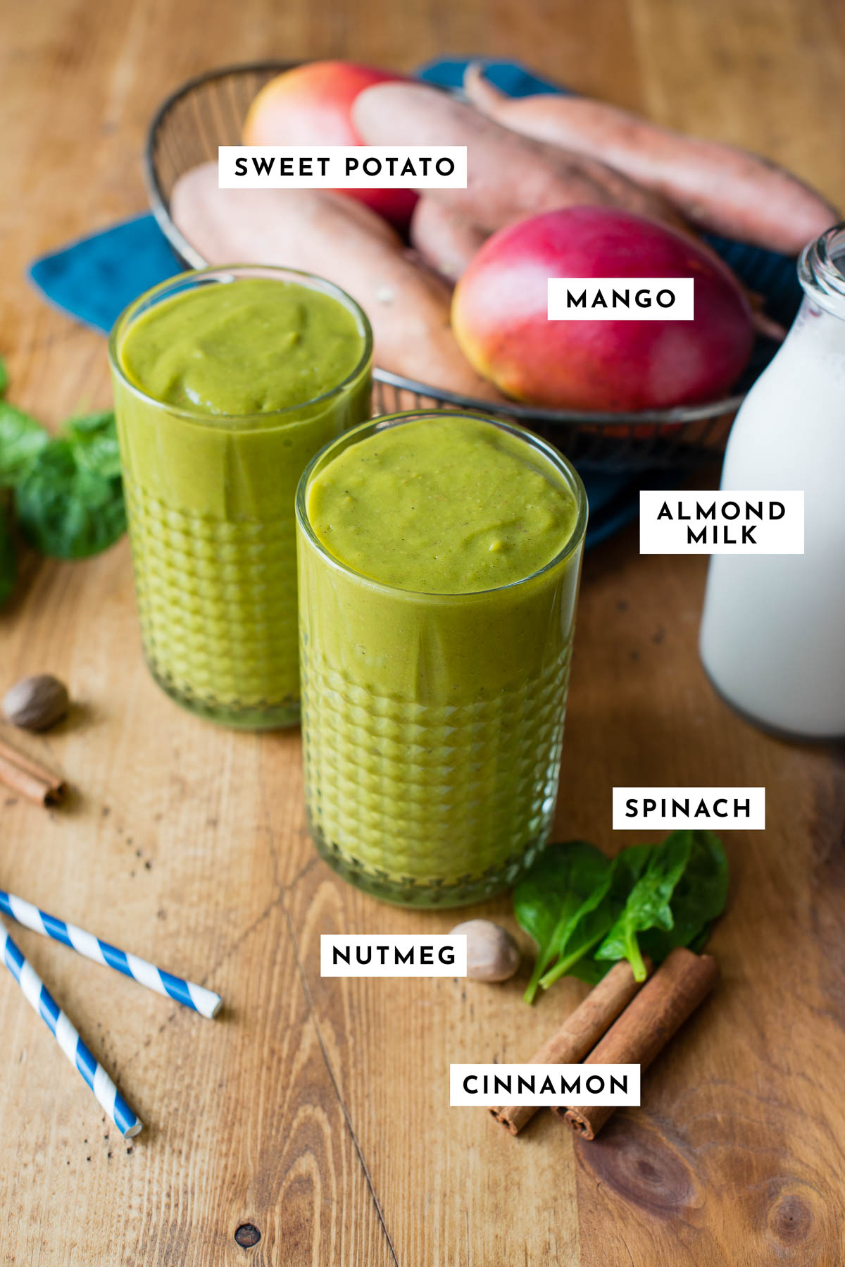 Ingredients for a sweet potato smoothie, including sweet potato, mango, almond milk, cinnamon, and nutmeg.