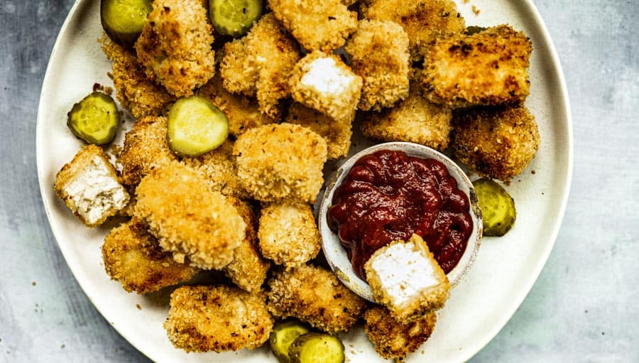 tofu nuggets recipe with pickles, ketchup and breadcrumbs— vegan chicken nuggets