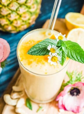 Refreshing pineapple lemon smoothie with mint and chamomile flowers.