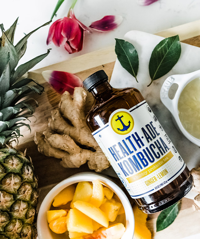 Bottle of kombucha and ginger for tutorial on hut health