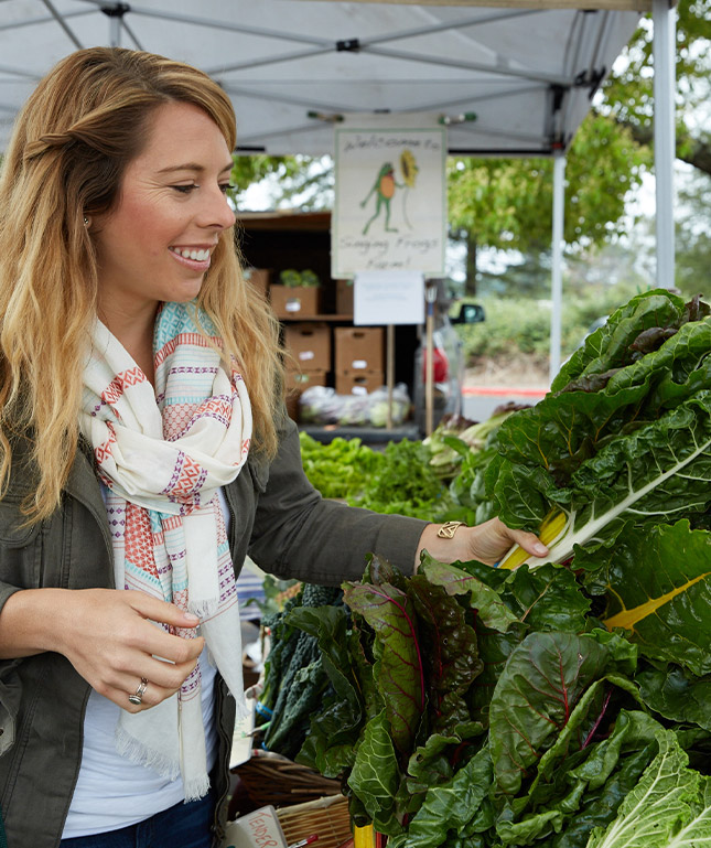 Jen Hansard at farmer's market shopping for chard
