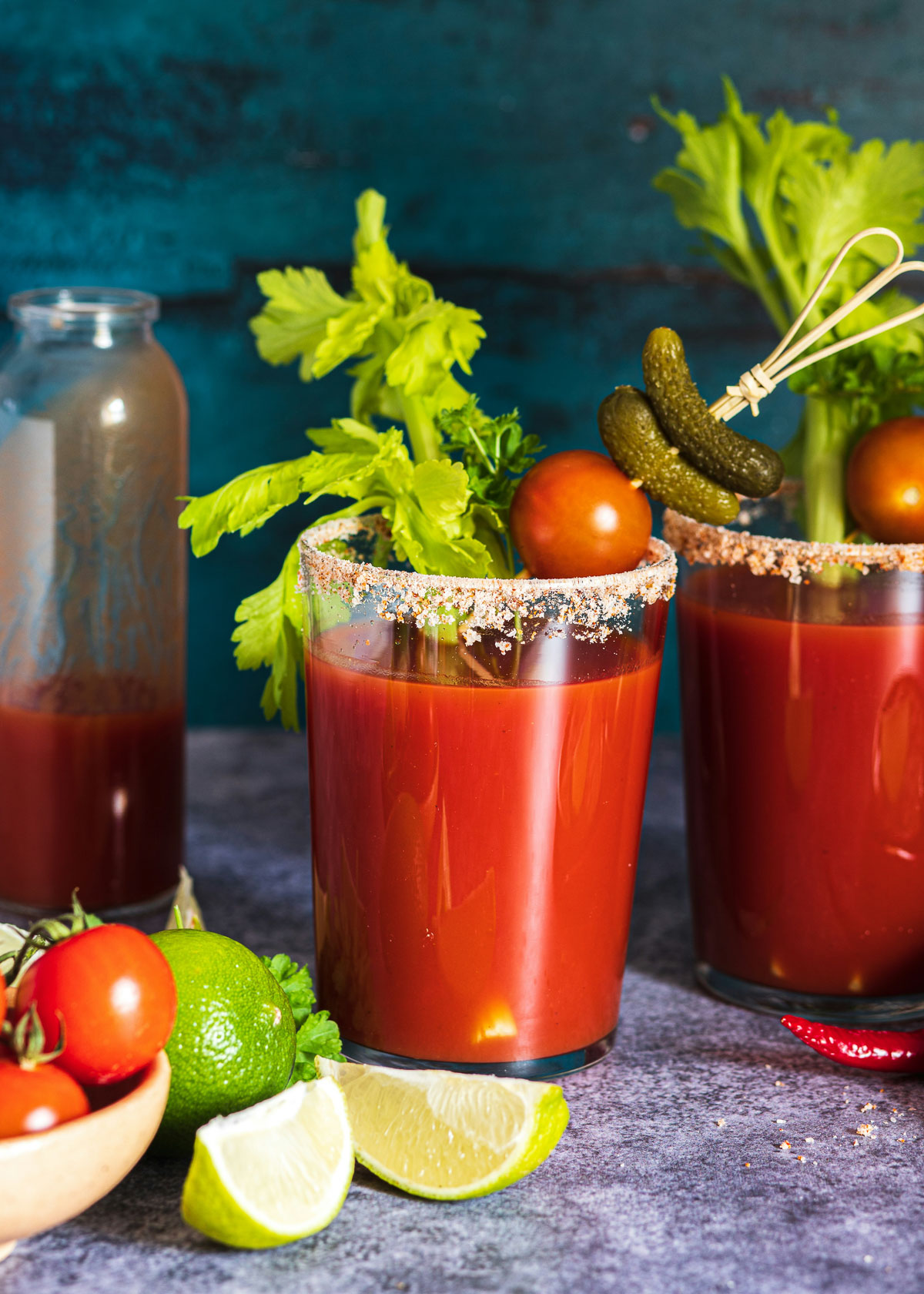 V8 tomato smoothie garnished bloody mary style with celery, pickles, and salted rim