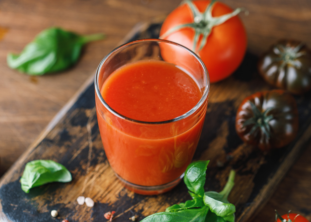 V8 tomato smoothie on a cutting board