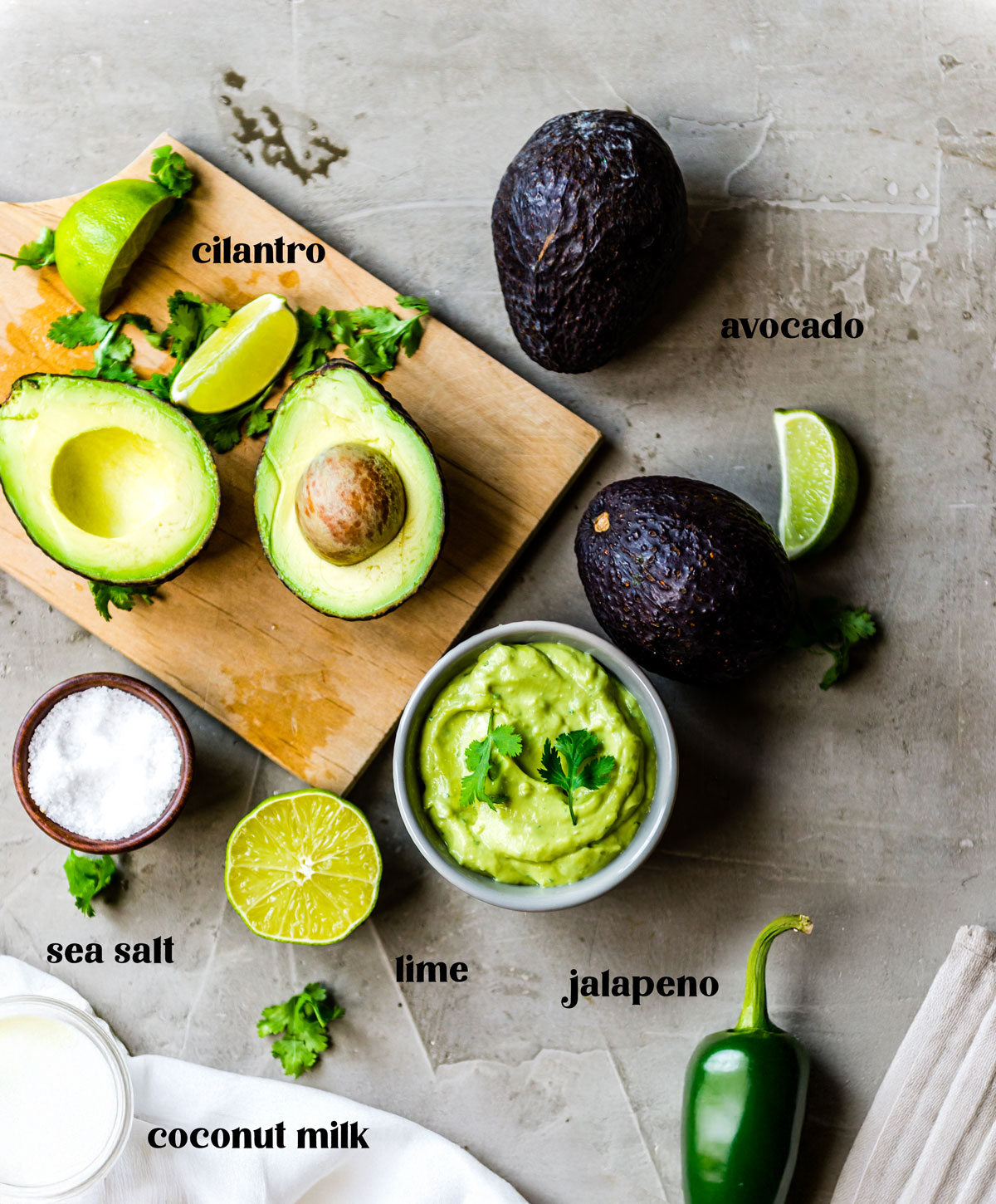Avocado crema ingredients on a wooden cutting board