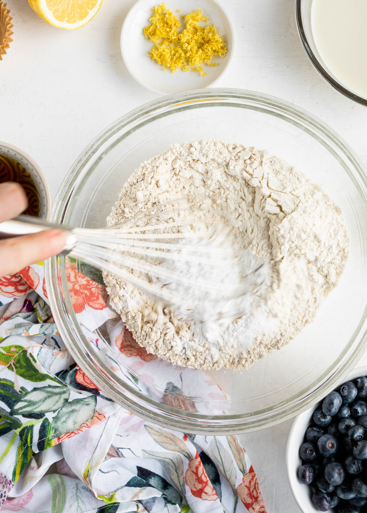 whisking together all-purpose and whole wheat flours.
