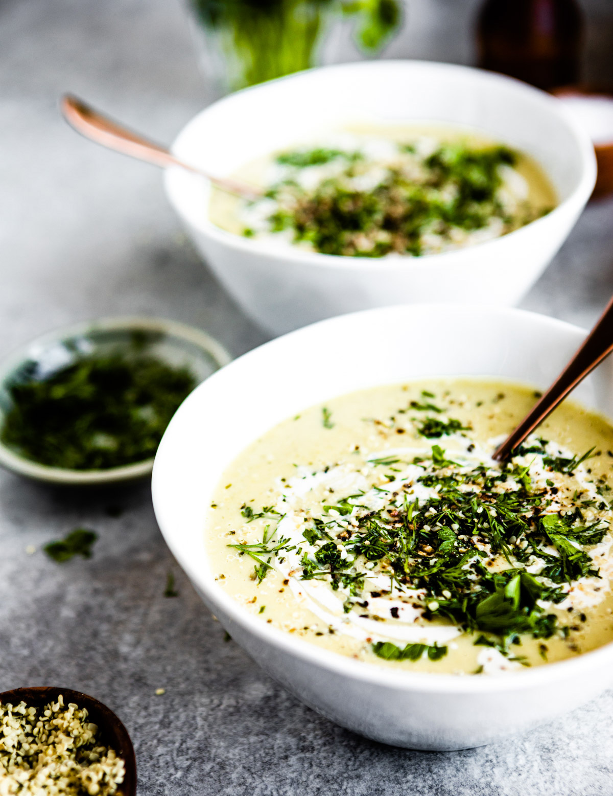 A bowl of celery soup on a gray countertop.