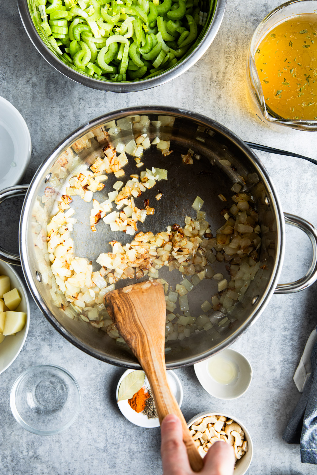 Sauteeing onions in a stainless steel pan.