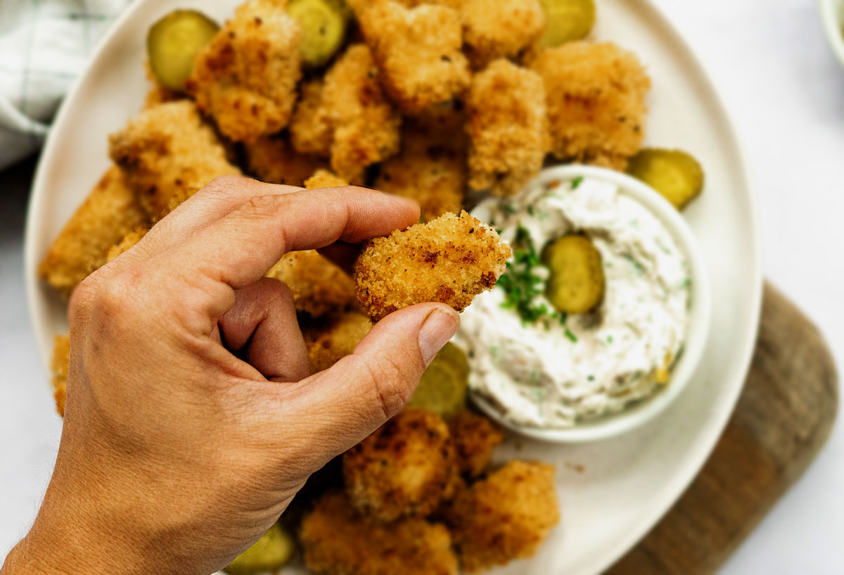 Close up of a crispy vegan chicken nuggets to show the breadcrumbs and tofu goodness.