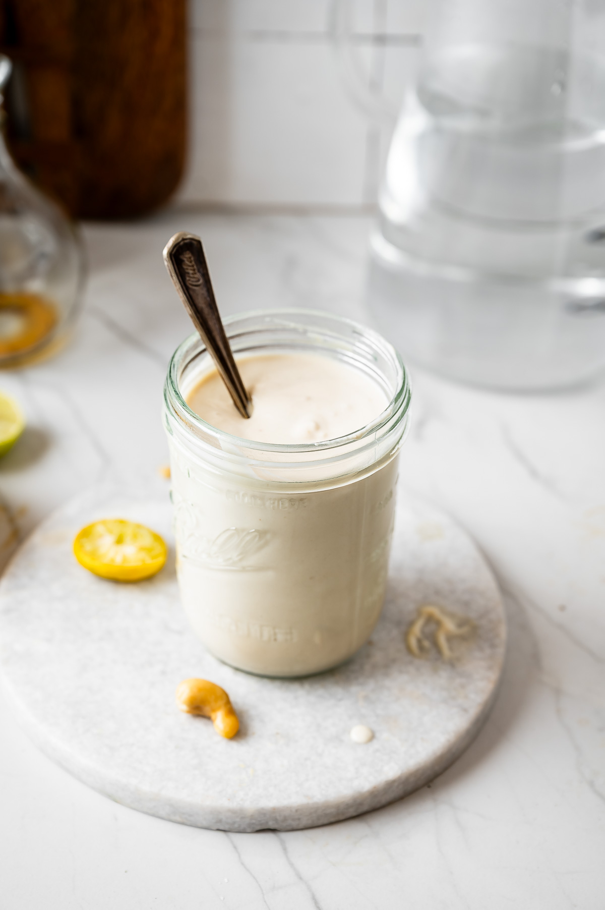 A jar of coconut yogurt with a spoon in it