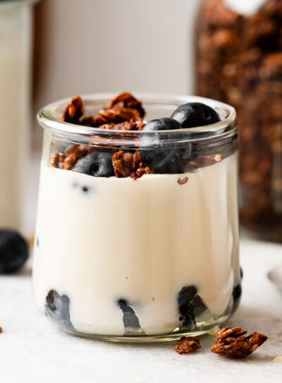 Creamy vegan coconut yogurt recipe layered with granola and fresh blueberries in a glass
