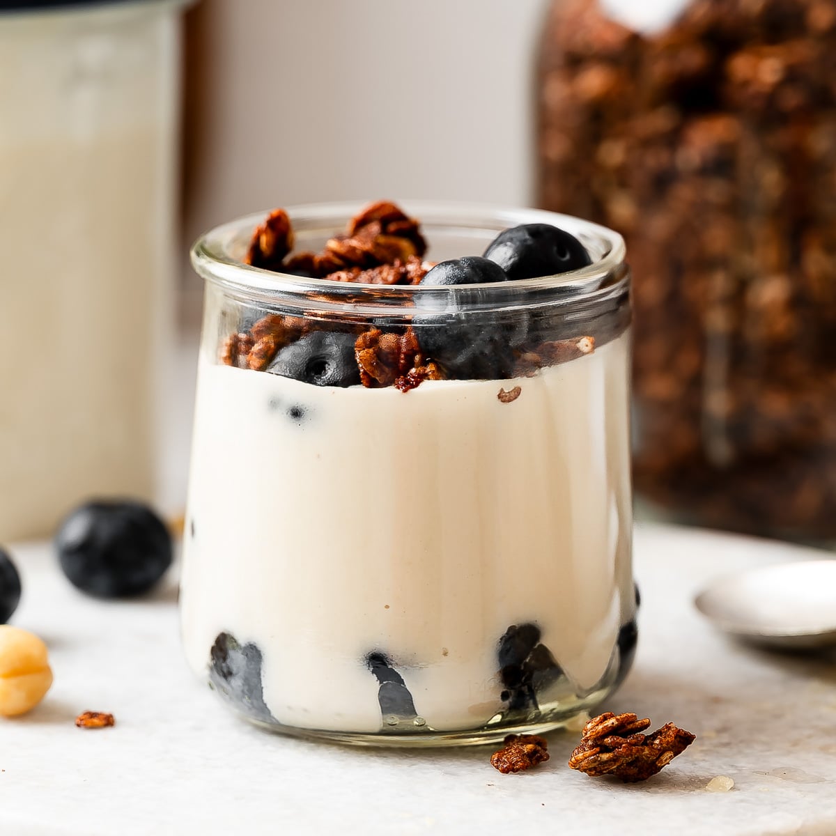 Creamy vegan coconut yogurt recipe layered with granola and fresh blueberries in a glass