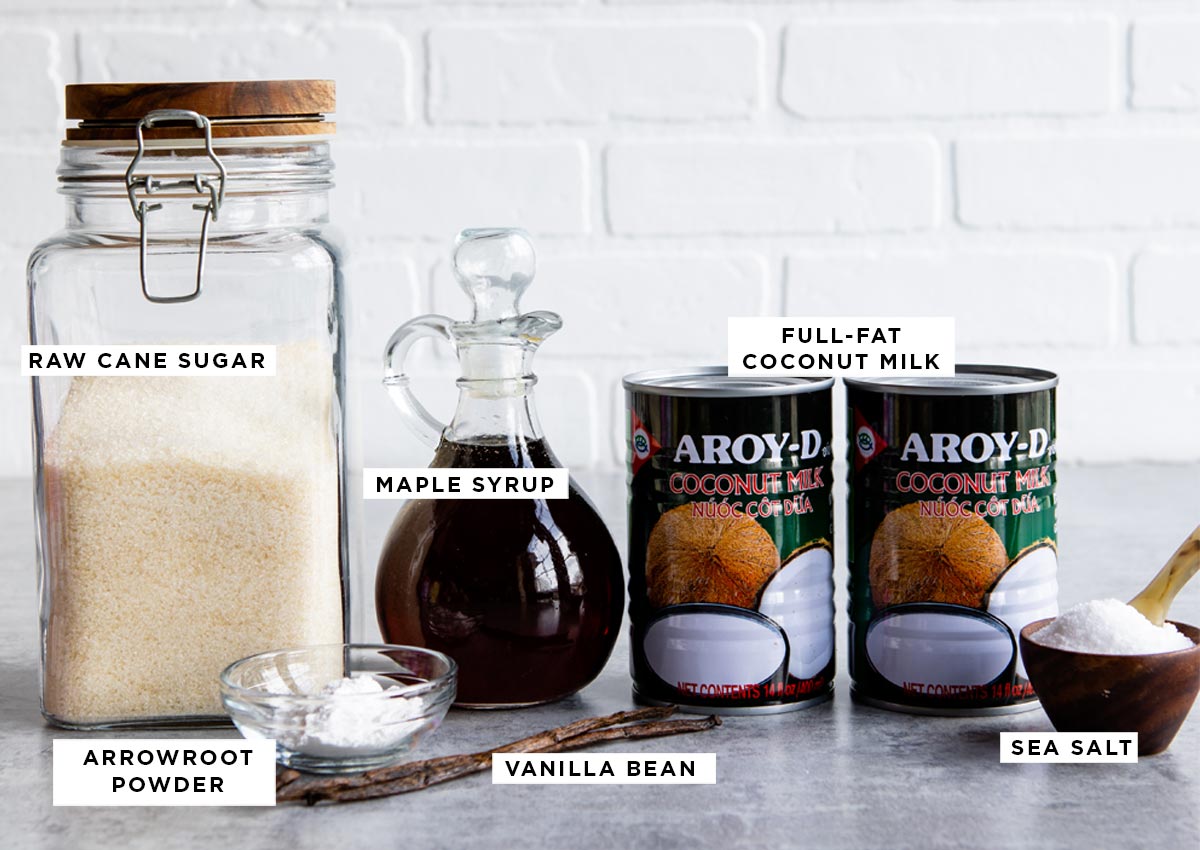 ingredients for vegan ice cream recipe including raw cane sugar, arrowroot powder, maple syrup, full-fat coconut milk, a whole vanilla bean and sea salt.