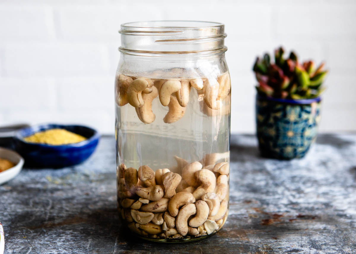 soaking cashews in mason jar for vegan cream cheese.