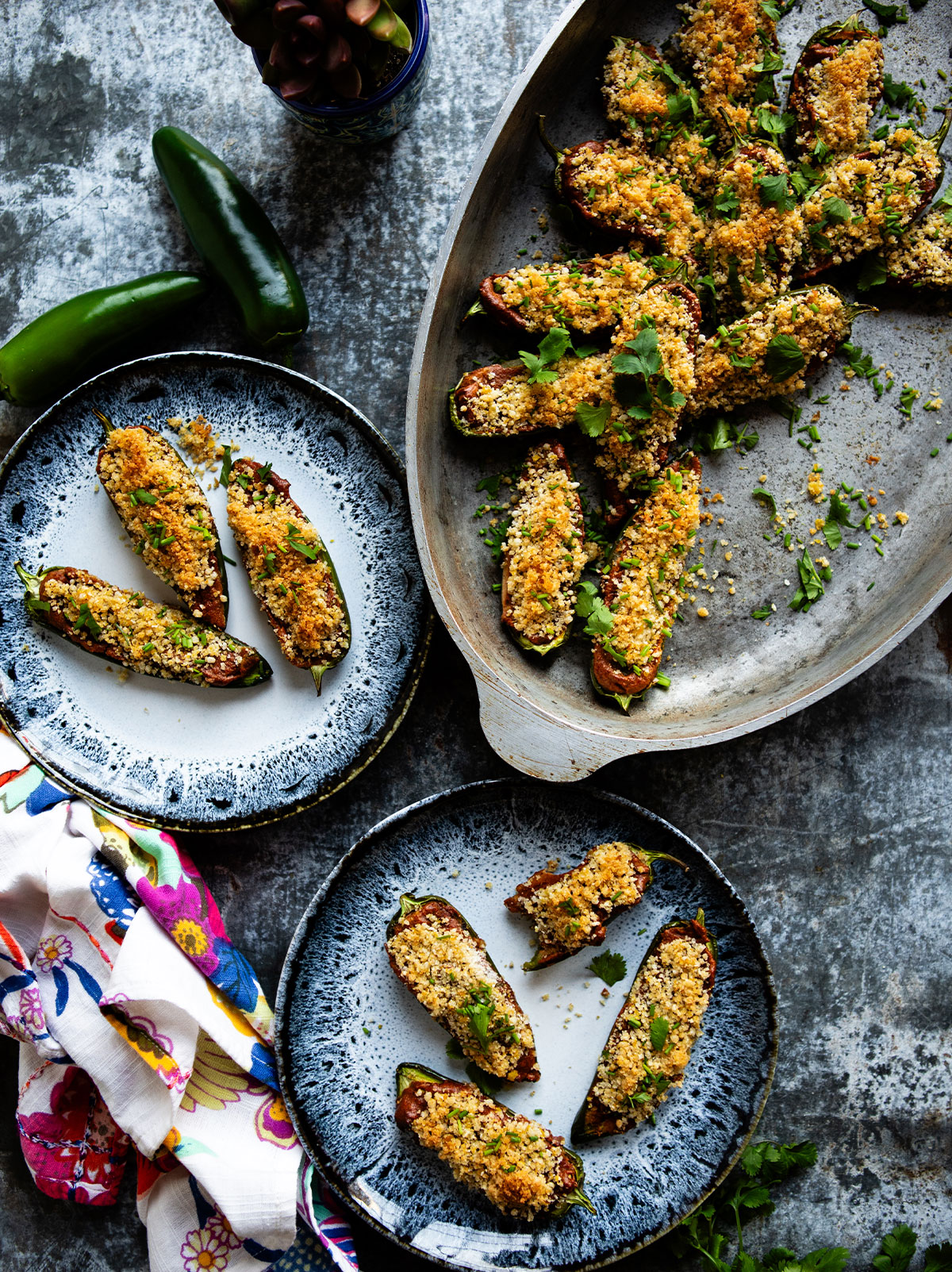 party table arrangement with plates of vegan jalapeño poppers.