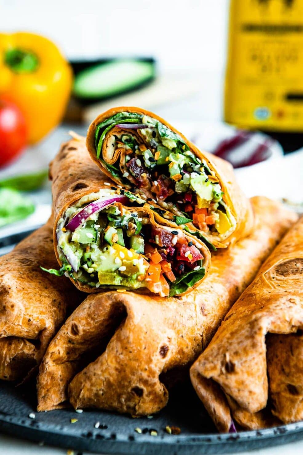 plant based wraps stuffed with cucumber, red onion, carrots, hummus, lettuce and everything bagel seasoning.