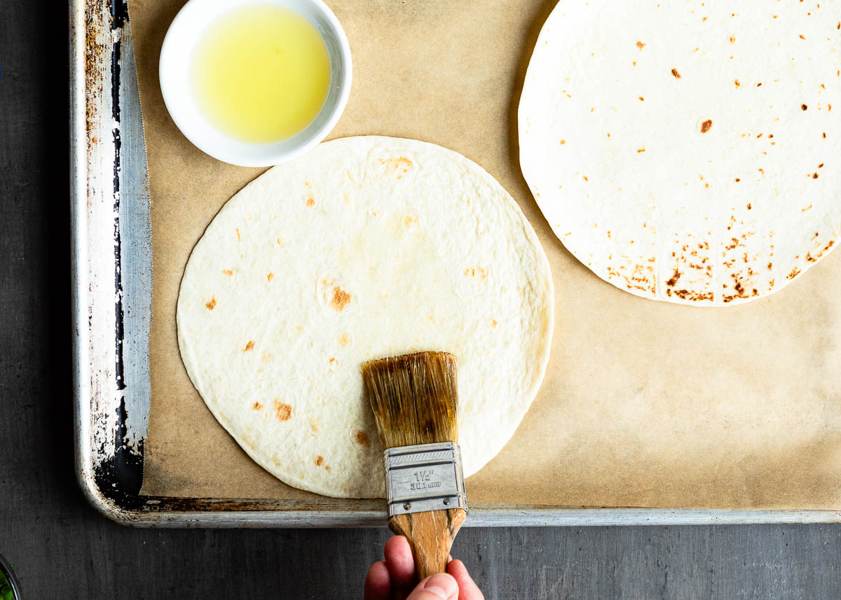 brushing tortilla shells with oil.