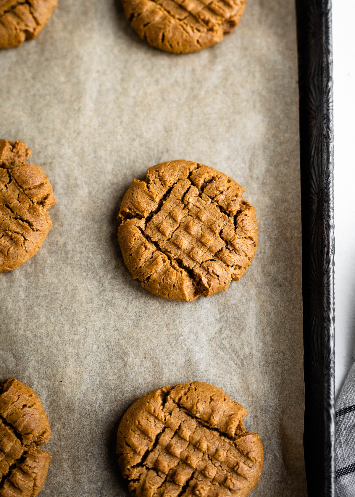 baked vegan peanut butter cookies up close with criss cross lines.