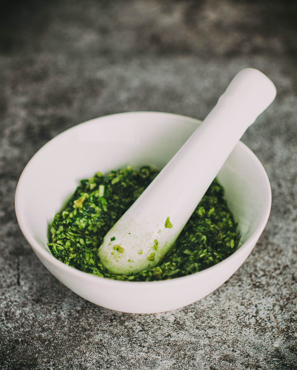 mortar and pestle with homemade pesto.