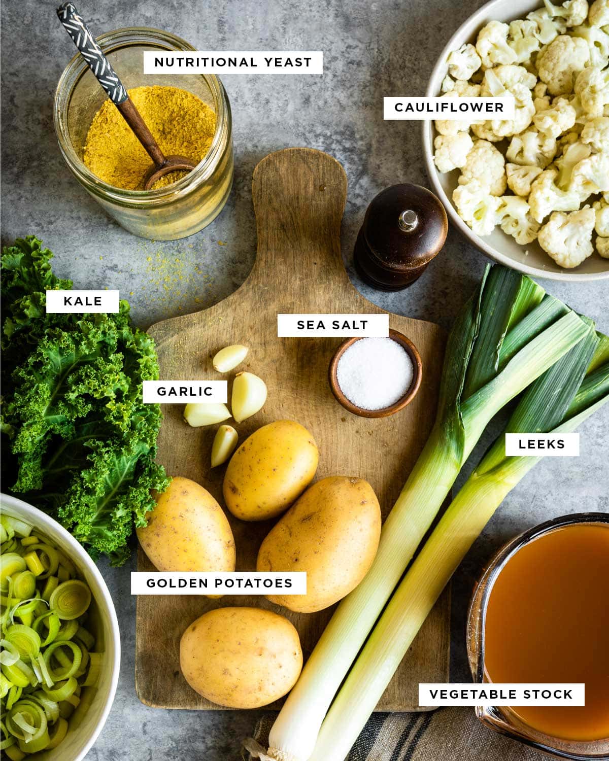 ingredients for potato soup including: nutritional yeast, cauliflower, kale, sea salt, garlic, leeks, golden potatoes and vegetable stock.
