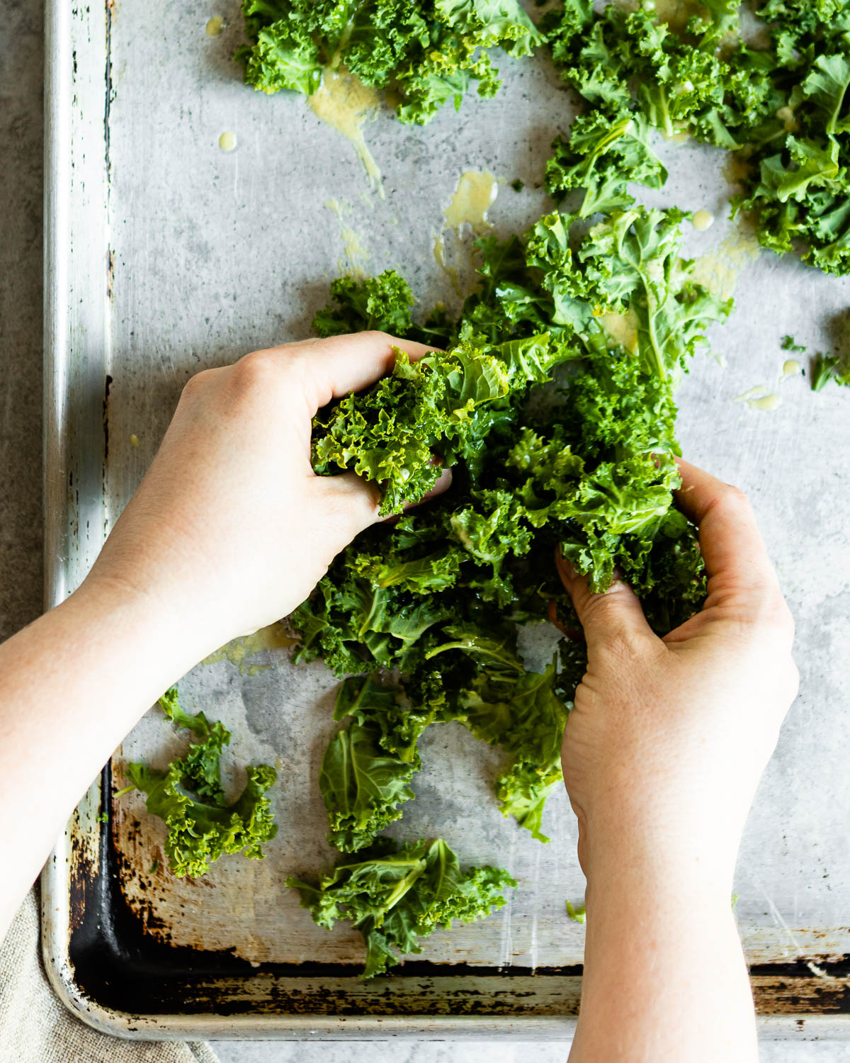 Shredded kale being massaged 