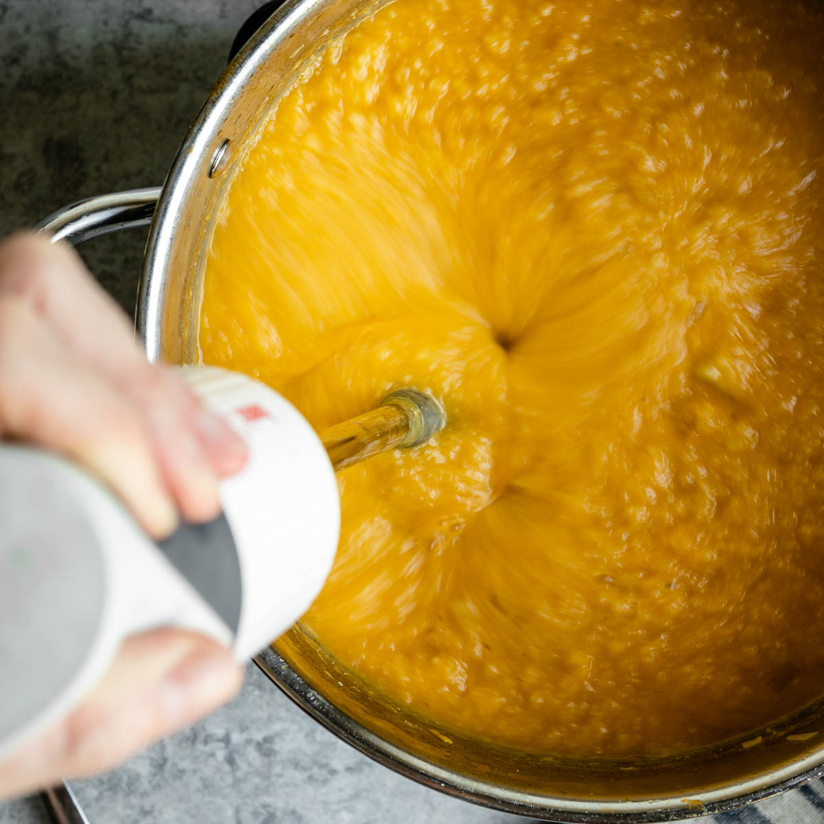 Blending vegan potato soup with a mixer