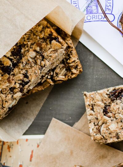 several vegan protein bars wrapped in parchment paper.