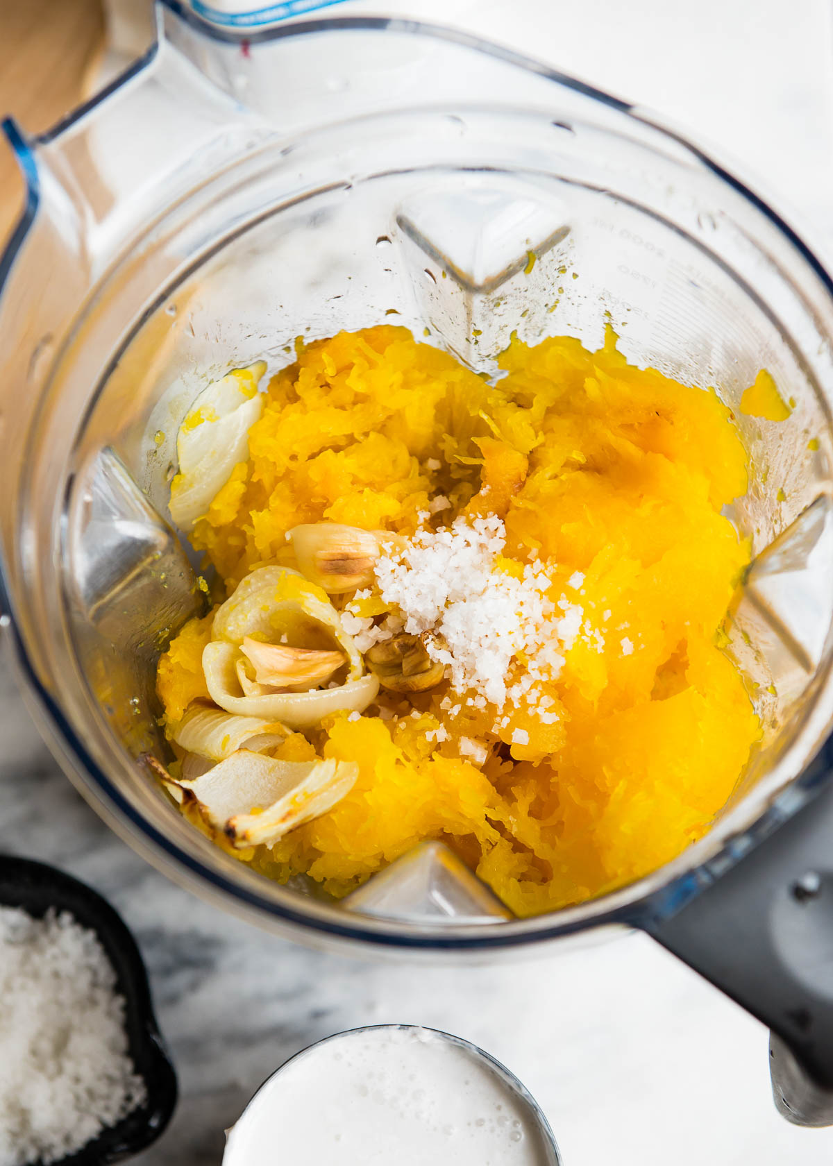 blender container with ingredients for pureed soup.