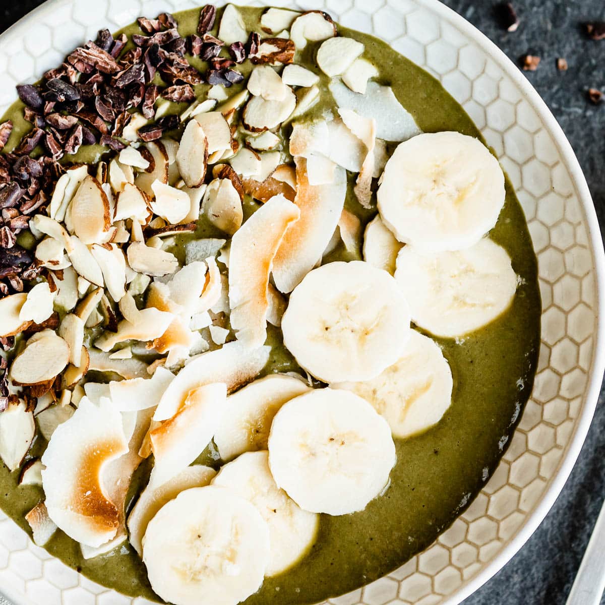 Coconut vegan smoothie bowl topped with banana slices.
