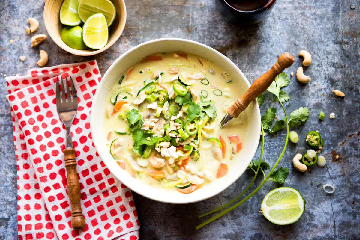 Thai coconut soup with lime, scallions and cashew for toppings.