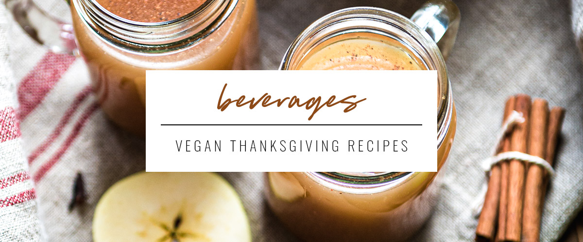 white box that says beverages, vegan Thanksgiving recipes overtop 2 glass mugs of apple cider.