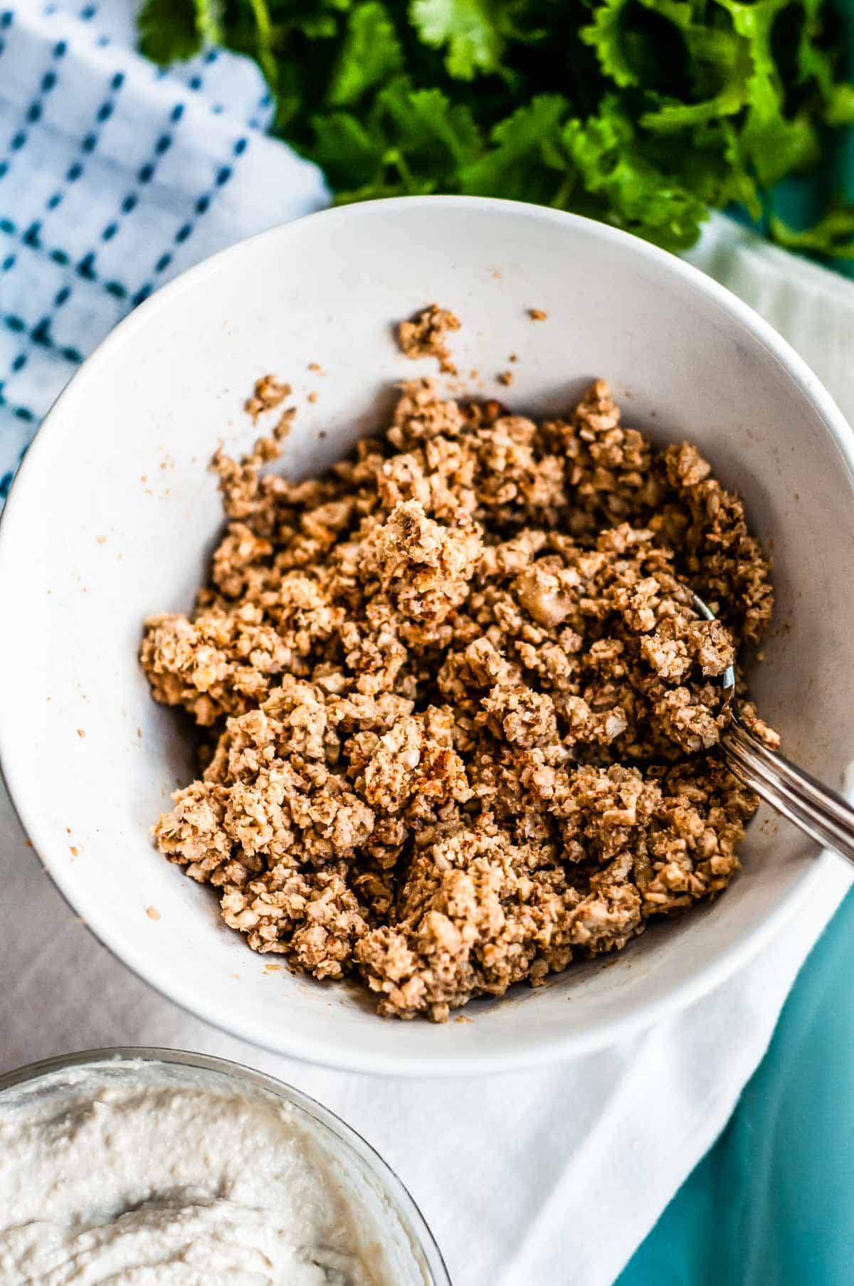 A bowl of walnut taco meat with a spoon