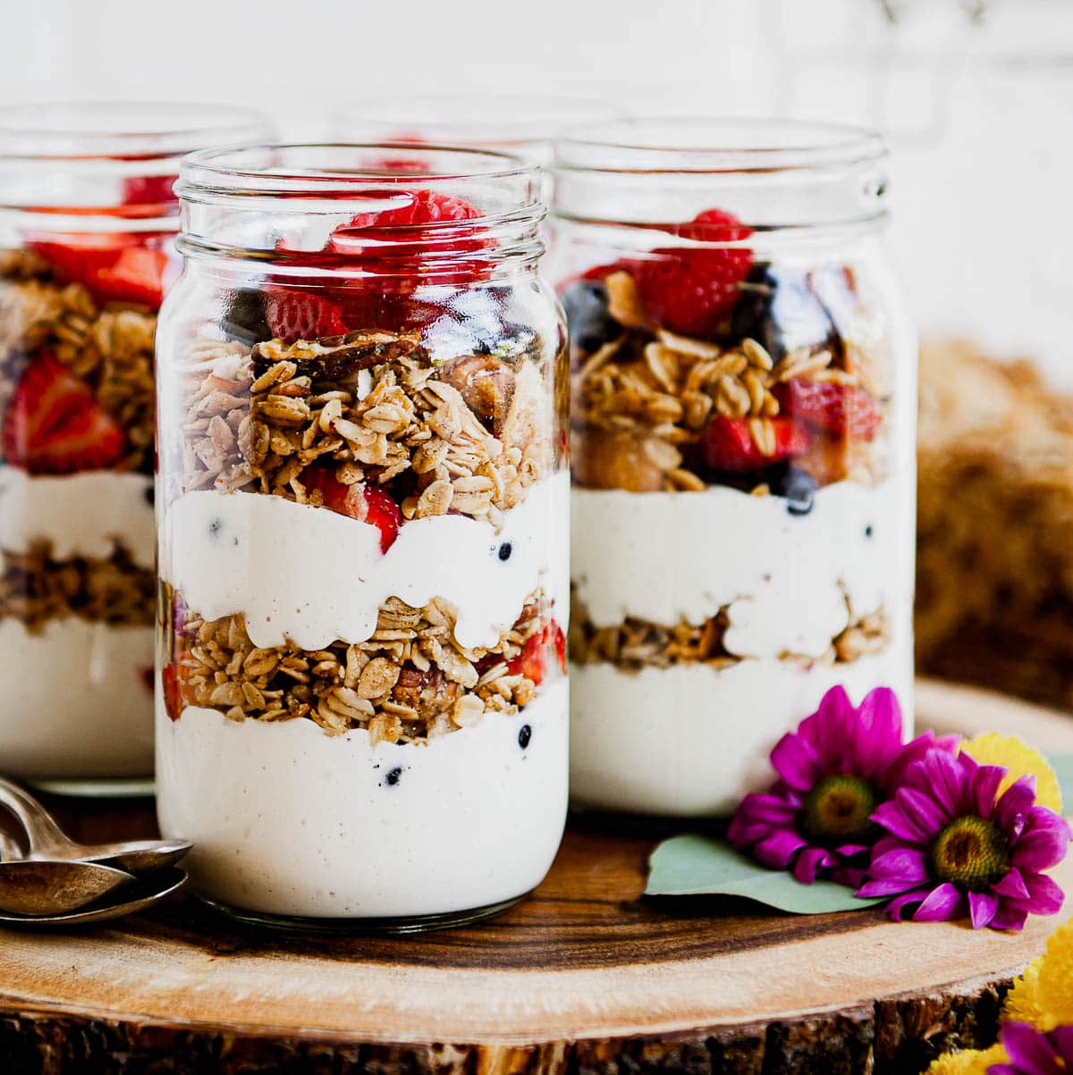vegan yogurt parfaits that include gluten free granola and fresh fruit in layers.